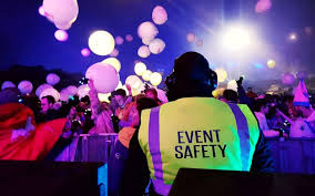 "The words 'EVENT' and 'SAFETY' are displayed in a bold, stylized font. An indeterminate figure is faintly visible in the background, suggesting a context related to event safety."